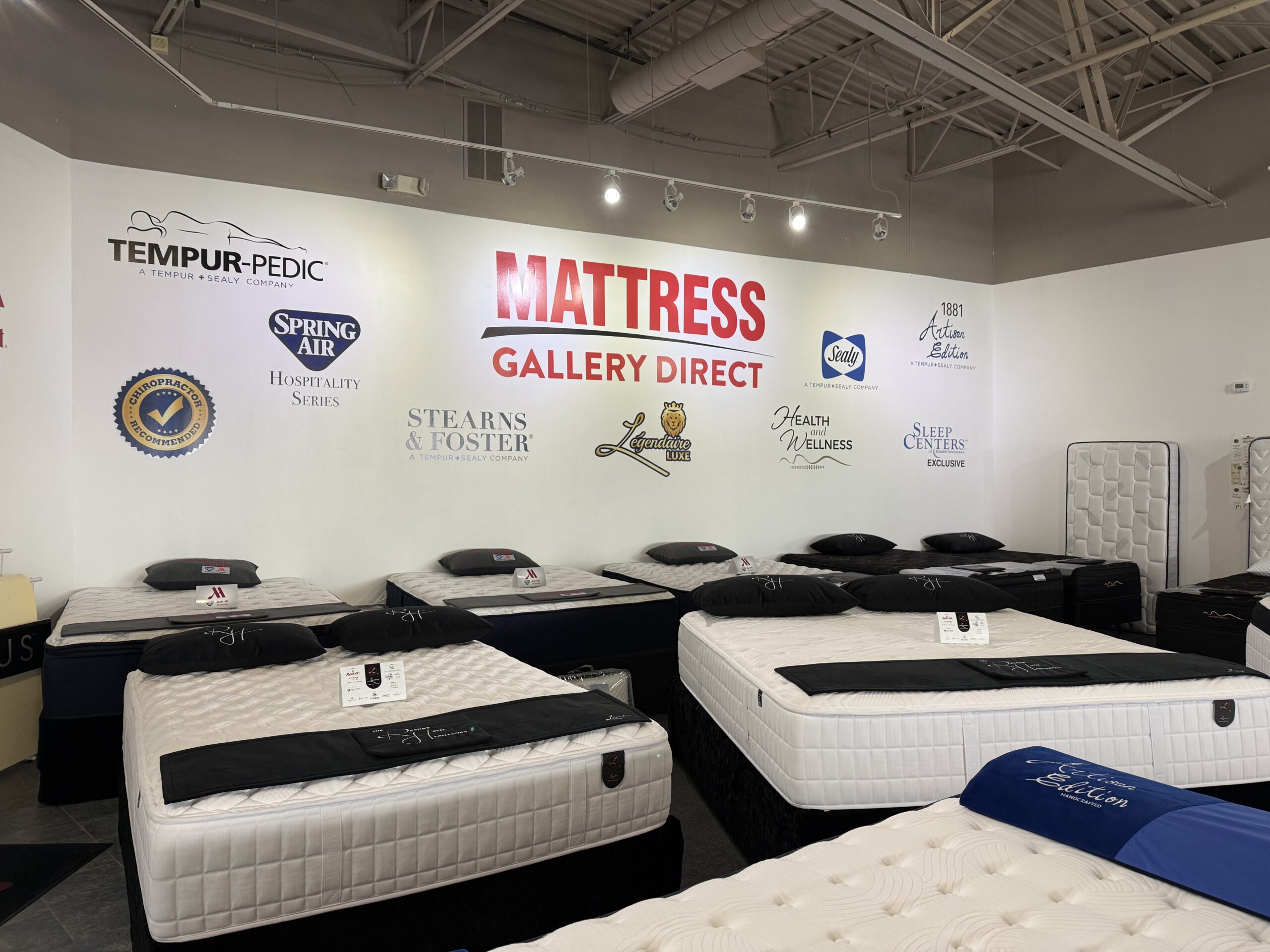 Family-owned Mattress Gallery Direct mattress store showroom in Smyrna TN with name-brand mattresses and sleep experts helping customers