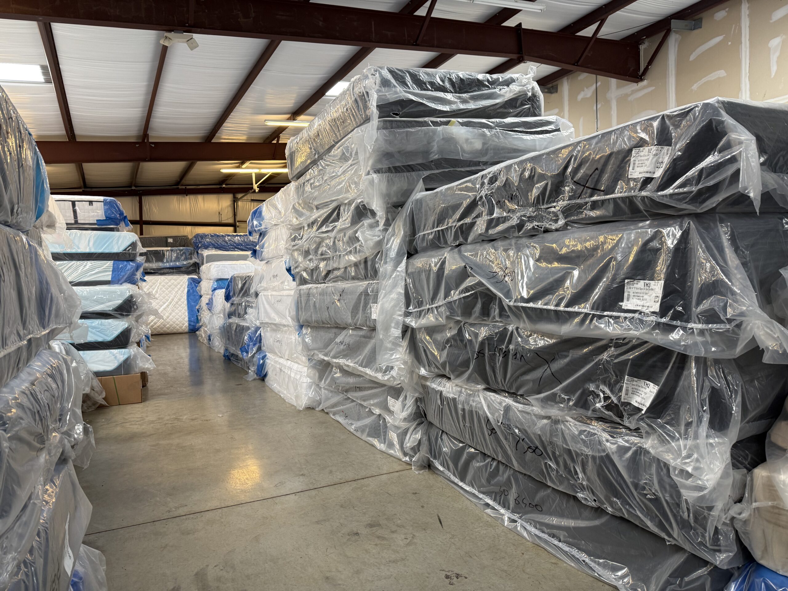Mattress Gallery Direct warehouse in Murfreesboro TN filled with in-stock Tempur-Pedic, Stearns & Foster, Sealy Hybrid, Spring Air Copper, and Legendaire mattresses ready for same-day deliver
